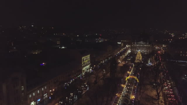 Lviv,-Ukraine---December-2018.-Arial-shot.-Lvov-Opera-house.-Christmas-tree.-Christmas-Fair.-People-are-walking-around-the-city-center.-Night-time
