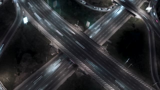 Traffic-on-freeway-interchange.-Aerial-night-view-timelapse-city-traffic.-UHD,-4K