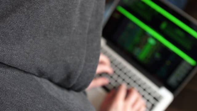 Anonymous-Hooded-Hacker-Programming-in-Computer-Console-Breaking-Password