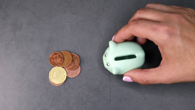 Hand-with-piggy-bank-and-coins
