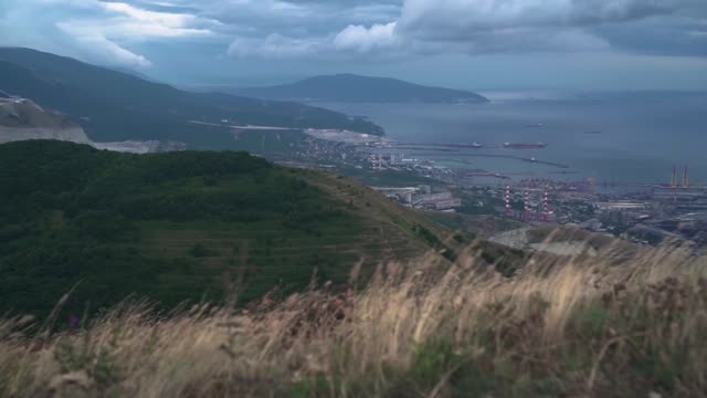 Footage-of-the-city-with-a-bay,-port,-buildings,-mountains.-Ariel-view-of-Novorossiysk.-Russia.