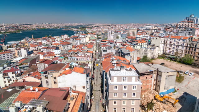 The-view-from-Galata-Tower-to-Golden-Horn-and-city-skyline-with-red-roofs-timelapse,-Istanbul,-Turkey