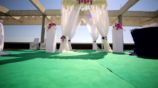 Wedding-arch-on-roof-of-a-high-building-under-sky.