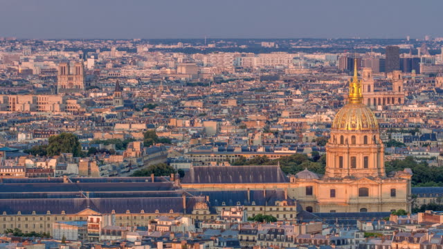 Aerial-view-of-a-large-city-skyline-at-sunset-timelapse.-Top-view-from-the-Eiffel-tower.-Paris,-France