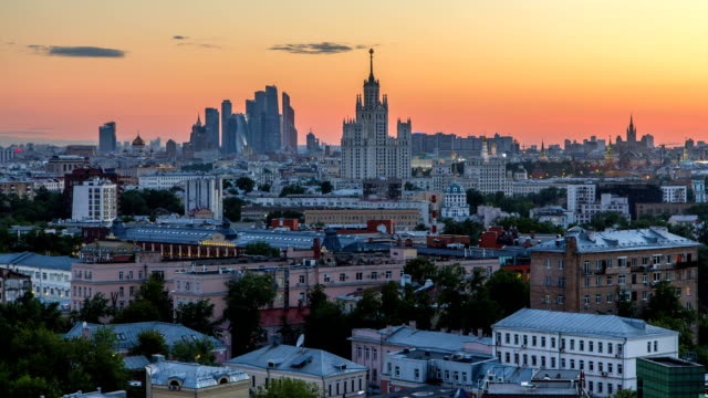 Skyscrapers-day-to-night-timelapse,-Kremlin-towers-and-churches,-stalin-houses-at-evening-aerial-panorama-in-Moscow,-Russia