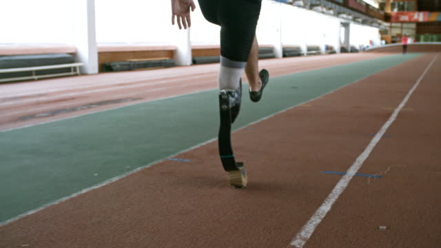 Unrecognizable-Man-with-Prosthetic-Leg-Training-on-Track