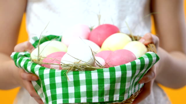 Little-child-holding-decorated-basket-with-Easter-egg-before-camera,-celebration