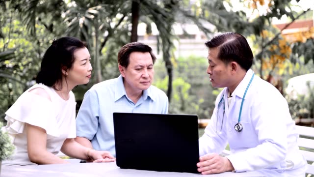 Doctor-and-patient-discussing-medical-examination-outdoor-in-garden.