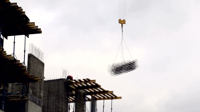 the-construction-crane-raises-the-weight-of-the-building-form-for-the-hardening-of-the-concrete