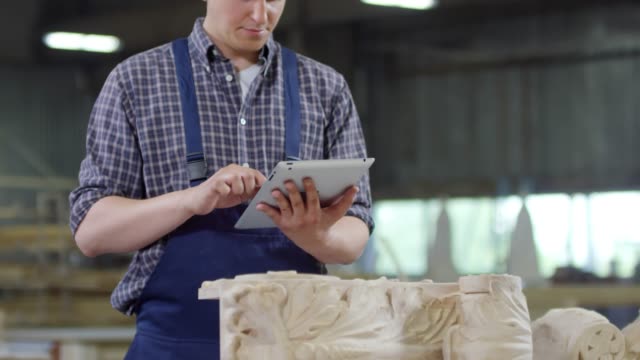 Carpenter-Working-on-Tablet