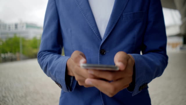 Cropped-shot-of-African-American-man-using-smartphone.