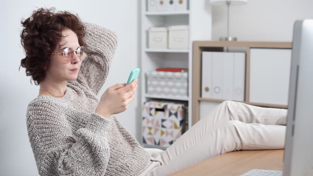 Young-Woman-Procrastinates-Scrolling-her-Smartphone
