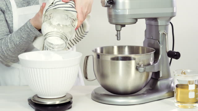Mixing-royal-icing-in-electric-kitchen-mixer-for-Easter-cookies.
