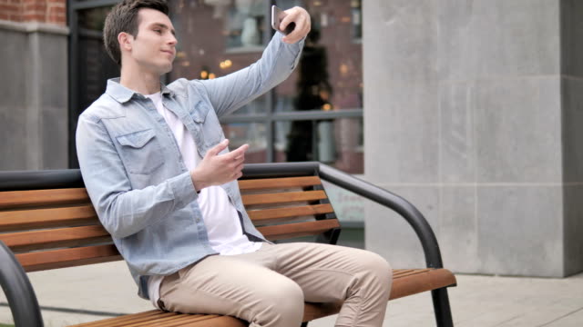 Outdoor-Young-Man-Taking-Selfie-on-Phone