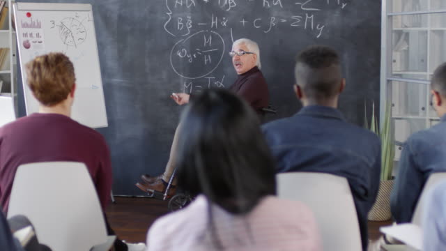 Professor-Writing-Equations-and-Explaining-Them