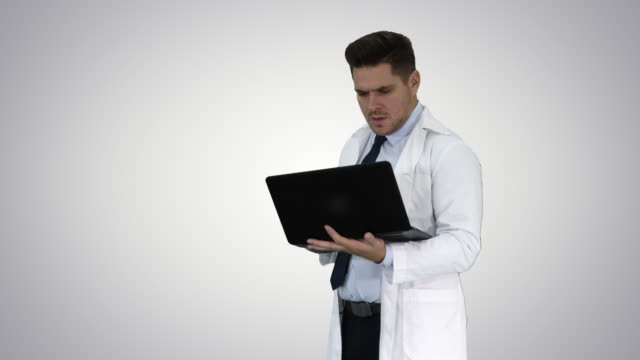 Doctor-showing-results-in-laptop-on-gradient-background