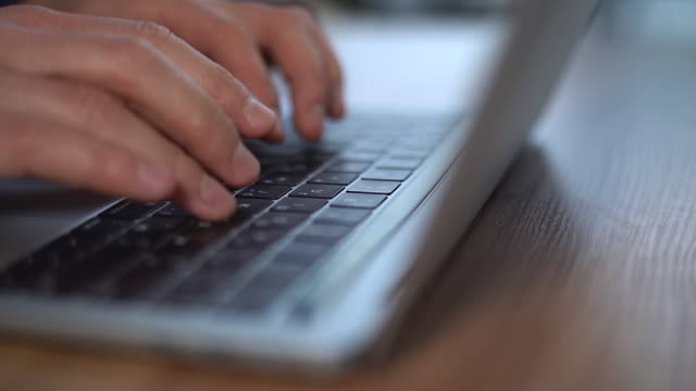 Hands-typing-on-computer-keyboard,-close-up