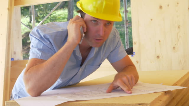 CLOSE-UP:-Architect-is-frustrated-with-builder-as-they-discuss-floor-plans.