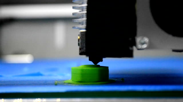 3D-printer-prints-green-shape-of-plastic-layers