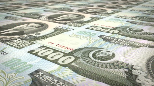 Banknoten-von-tausend-Won-von-Nordkorea-rollen,-Bargeld,-Schleife