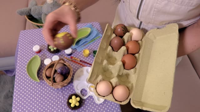 Woman-sorting-eggs-near-table