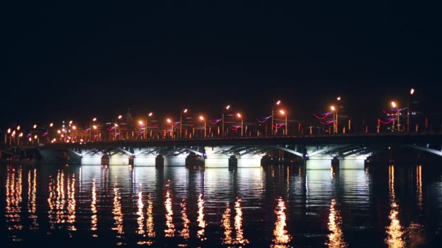 Chernavsky-Bridge-with-illumination-at-night-and-reflection-of-lights-in-water,-Voronezh