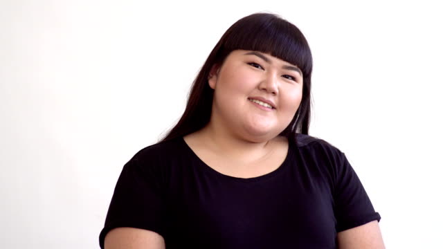 young-beautiful-overweight-Asian-girl-on-white-background-smiling.-Happy-Authentic-woman