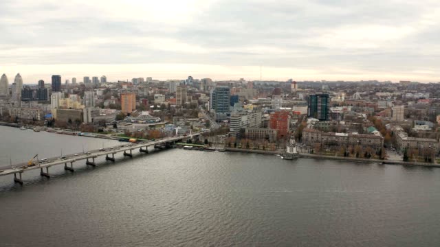 Aerial-view-footage-of-Dnieper-river.-Flying-over-cityscape-with-buildings.
