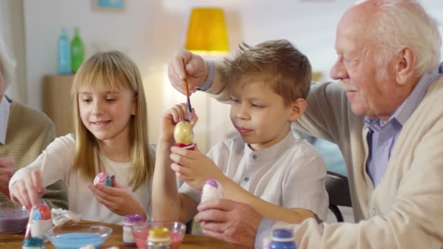 Family-Smiling-when-Decorating-Easter-Eggs