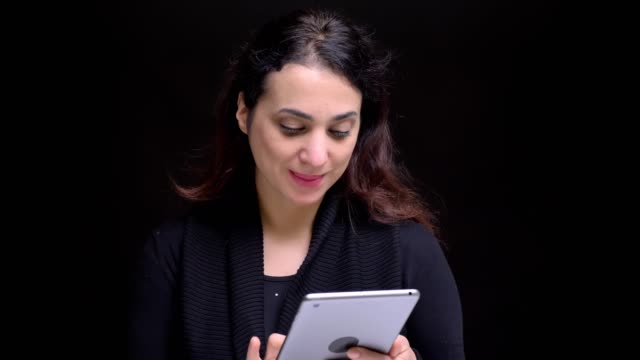 Closeup-portrait-of-young-attractive-caucasian-female-browsing-on-the-tablet-in-front-of-the-camera.
