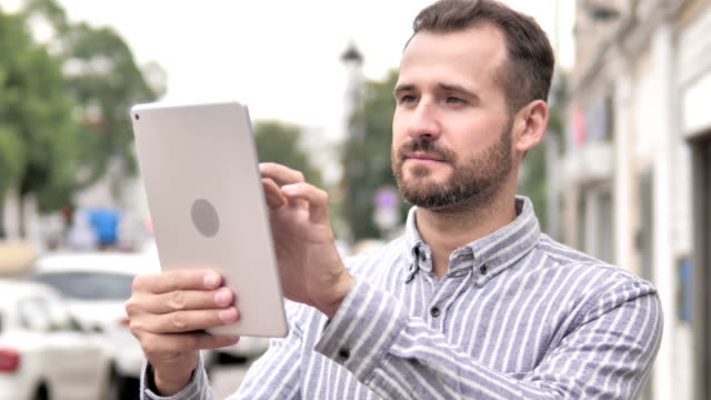 Beard-Casual-Man-Using-Tablet-Outdoor