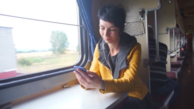 girl-in-headphones-using-a-train-smartphone