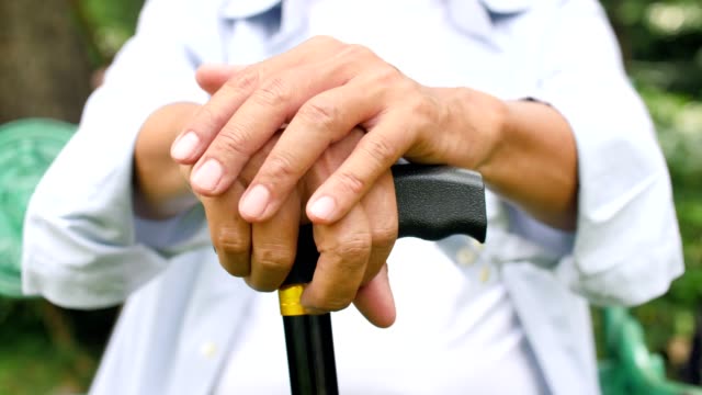 Close-up-of-senior-man-hands-holding-a-cane