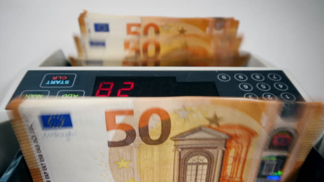 Modern-counting-device-calculates-euros-bills.
