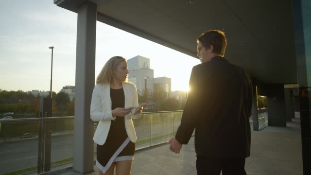 LENS-FLARE:-Businessman-argues-with-woman-after-colliding-with-her-at-sunset.