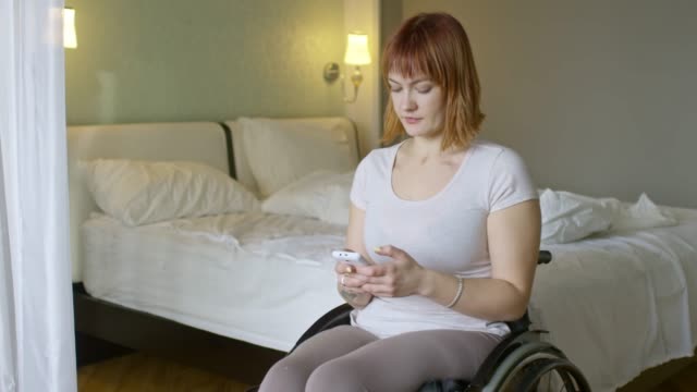 Woman-in-Wheelchair-Typing-on-Mobile-Phone