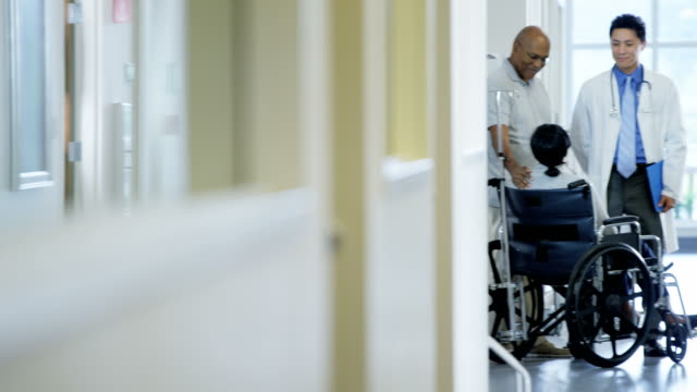 Ethnic-disabled-female-in-wheelchair-in-medical-centre
