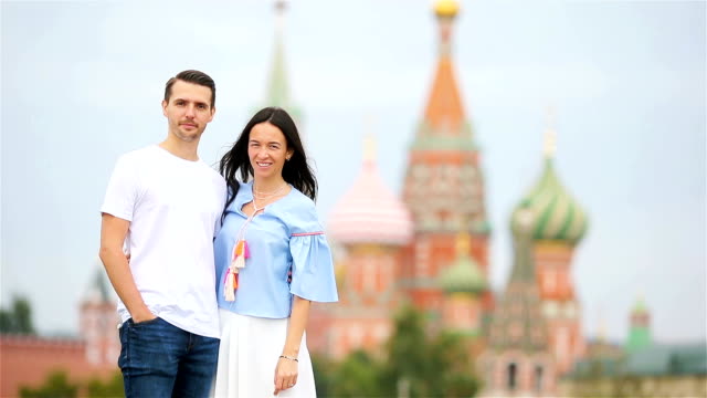 Young-dating-couple-in-love-walking-in-city-background-St-Basils-Church