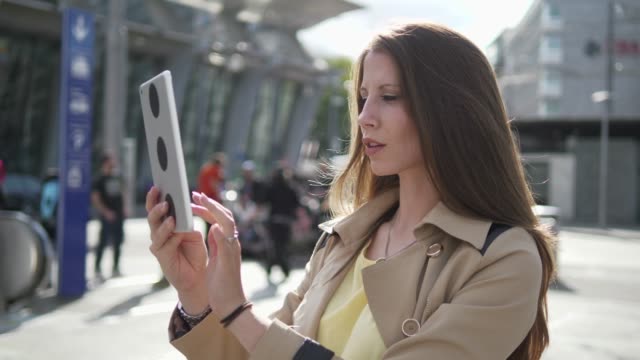 Young-attractive-Caucasian-woman-using-tablet-computer-at-train-station