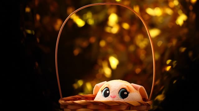 toy-rabbit-basket-gold-bokeh-hd-footage