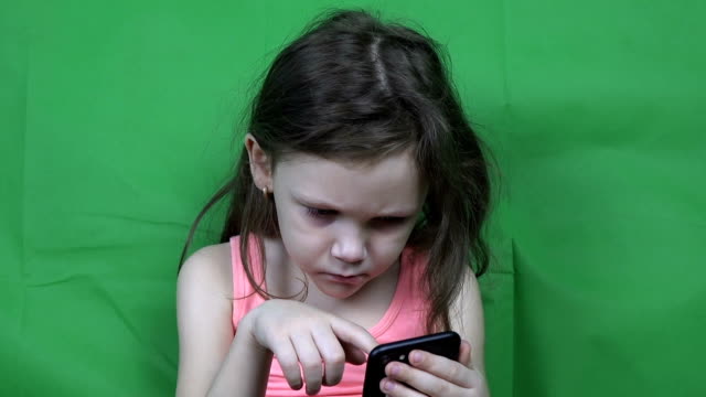 Little-girl-watching-video-on-a-smartphone