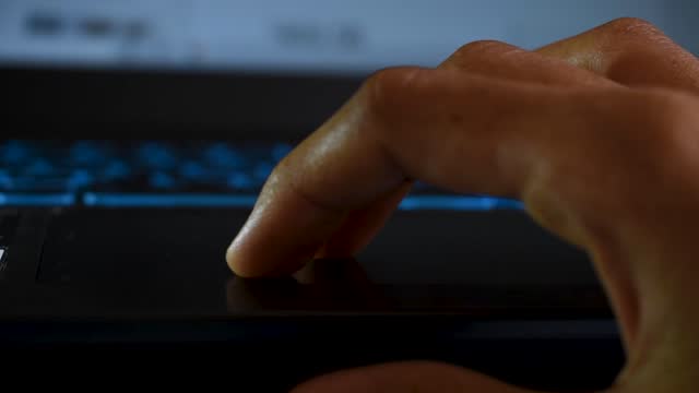 Close-up-shot-of-hands-of-a-female-using-laptop-via-touchpad
