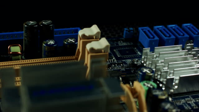 components-of-the-motherboard-are-spinning-on-a-black-background,-sata-slots-and-RAM