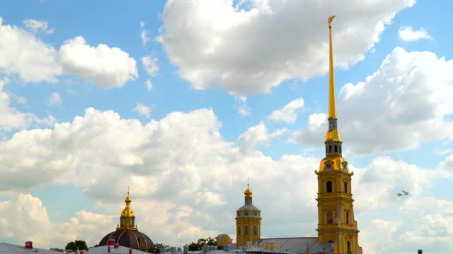 Towers-of-the-Peter-and-Paul-Fortress-against-a-background-of-white-clouds
