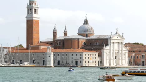 VENICE,-ITALY,-SEPTEMBER-7,-2017:-A-romantic-walk-along-the-famous-Grand-Canal-on-a-pleasure-tourist-boat,-Cathedral-of-San-Giorgio-Maggiore-on-the-island-of-the-Venetian-lagoon-San-Giorgio-Maggiore