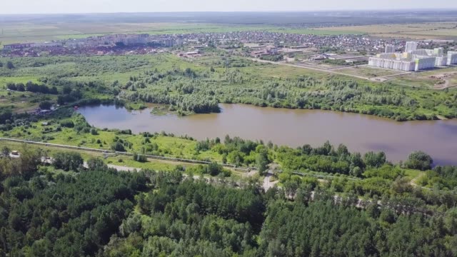 Aerial-view-of-forest-river-during-summer.-Clip.-Aerial-view-of-woodlands-with-river-in-the-summer-during-a-flight