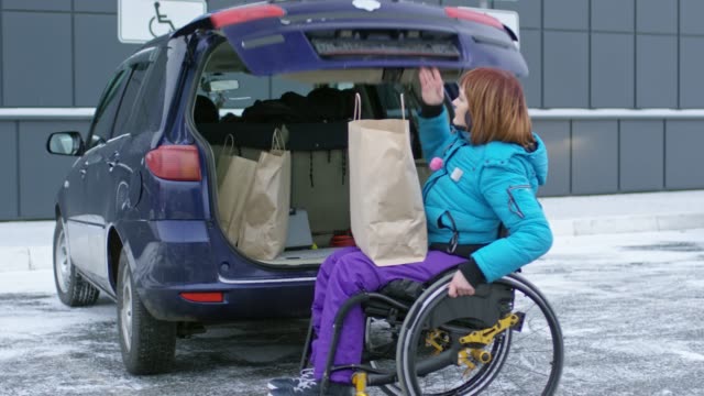 Disabled-Female-Driver-Loading-Shopping-Bags-in-Car