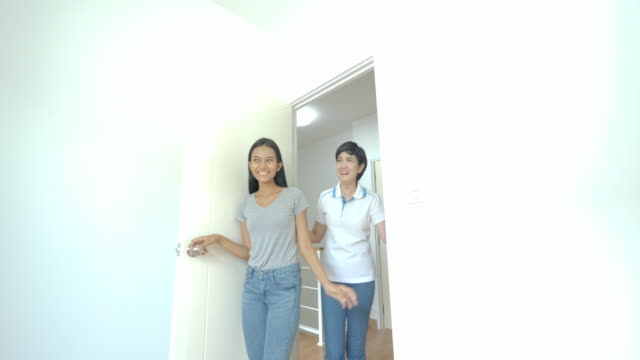 Happy-asian-women-LGBT-lesbian-couple-moves-into-a-new-apartment