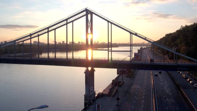 Aerial-shooting-pedestrian-bridge-of-Kiev-on-sunrise.-Summer-morning-in-Kiev-Dniepeer-river.-Ukraine.-European-city