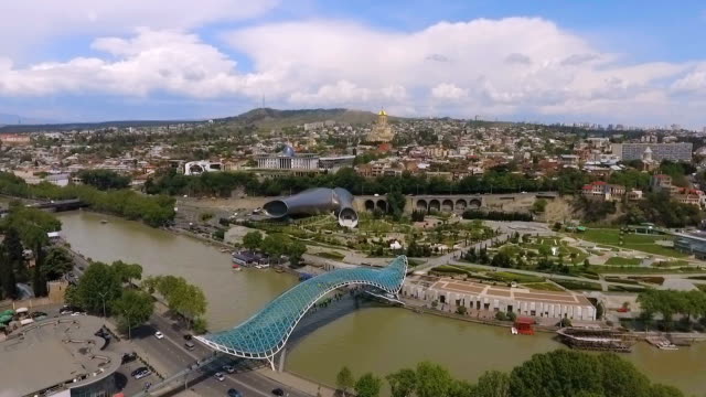Bridge-of-Piece-in-Tbilisi,-futuristic-construction-in-modern-city,-aerial-view